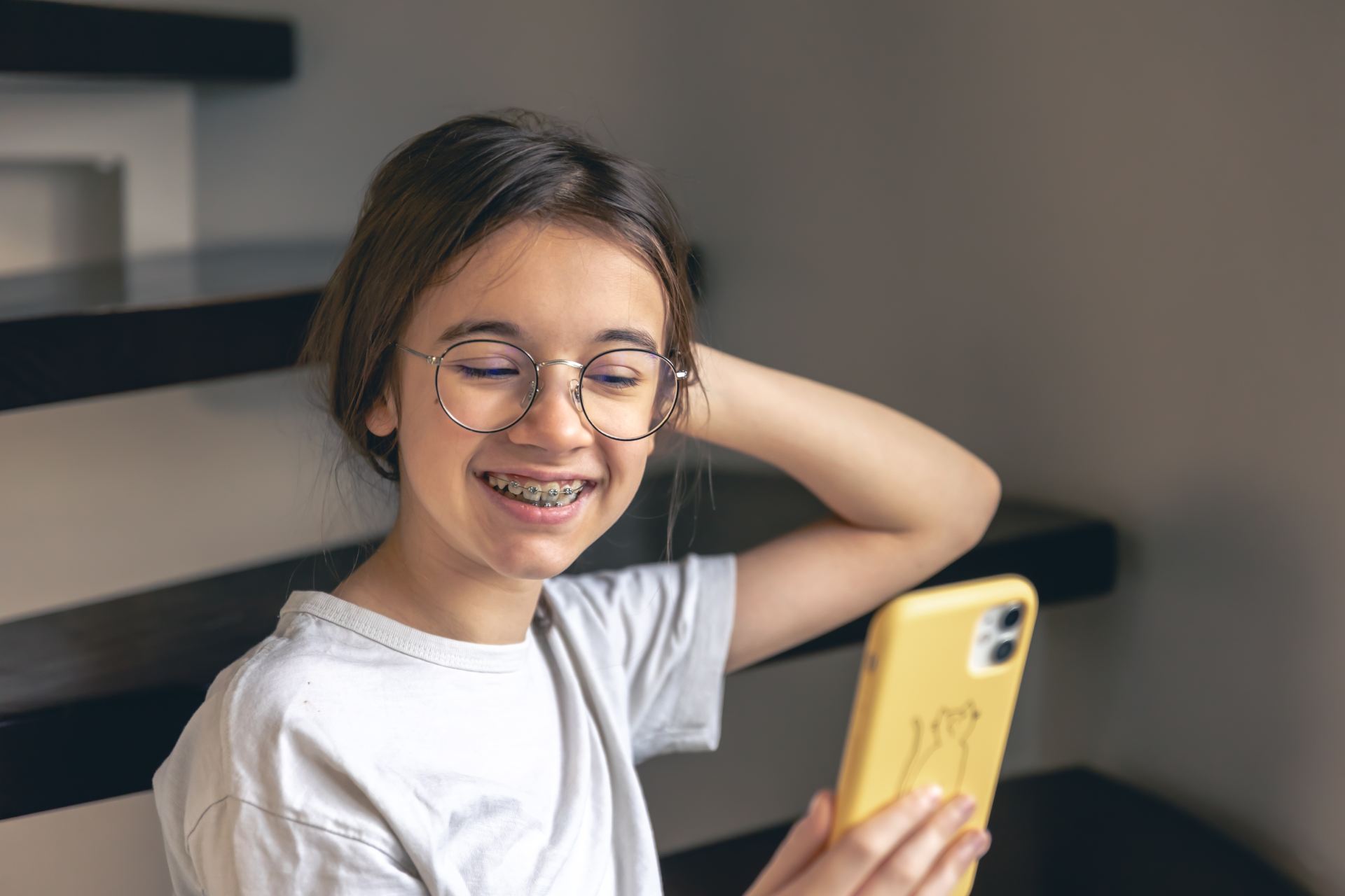 A girl with braces posing for a picture