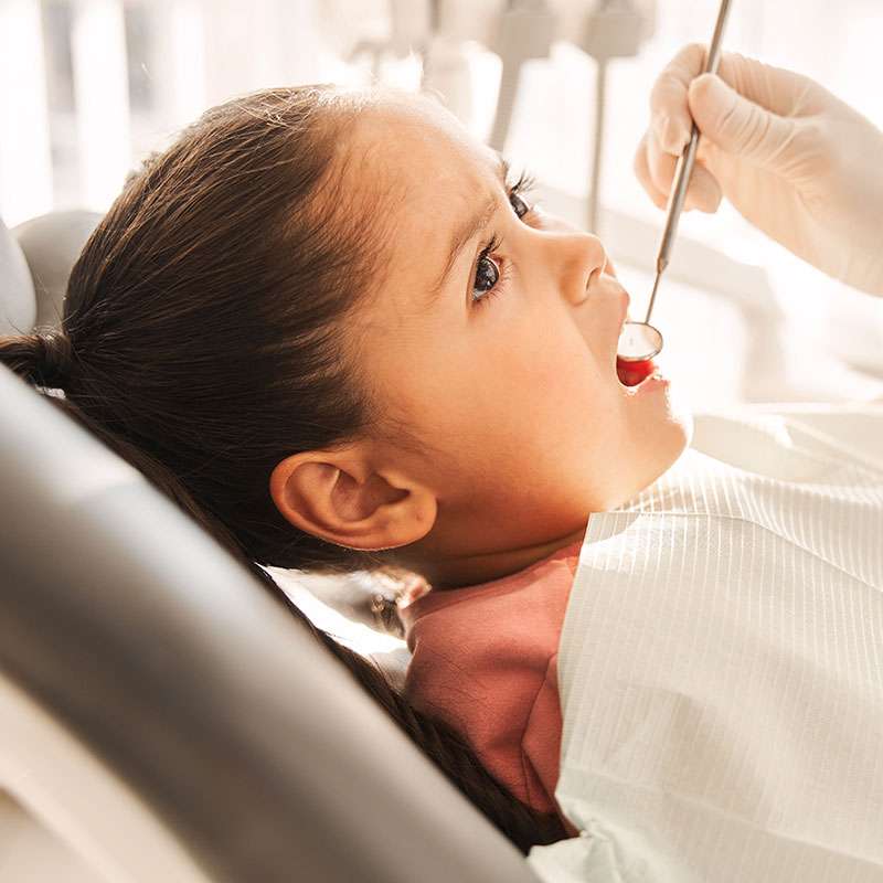 Girl smiling during her dental exam at Canton Orthodontics