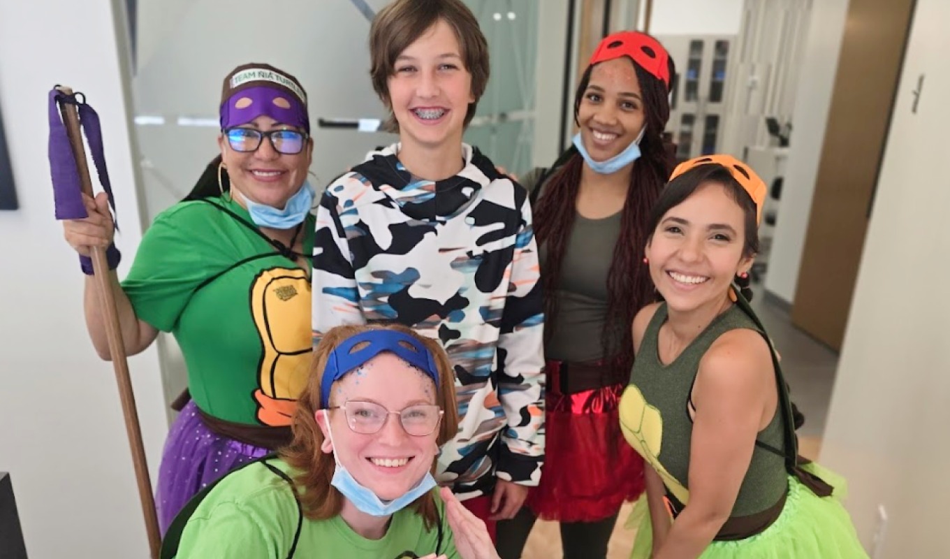 The orthodontic team in costume with a patient.