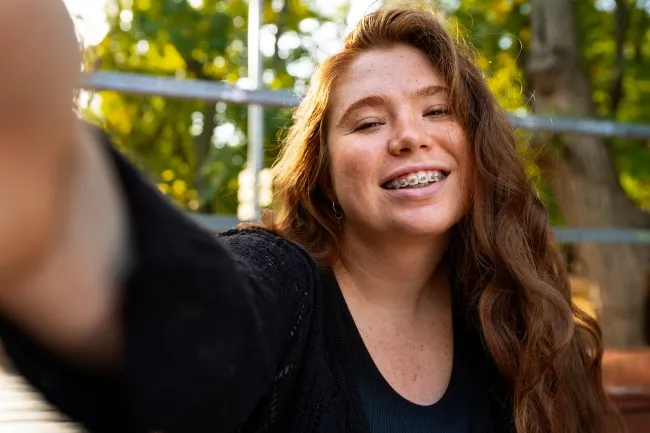 A woman smiling with braces.