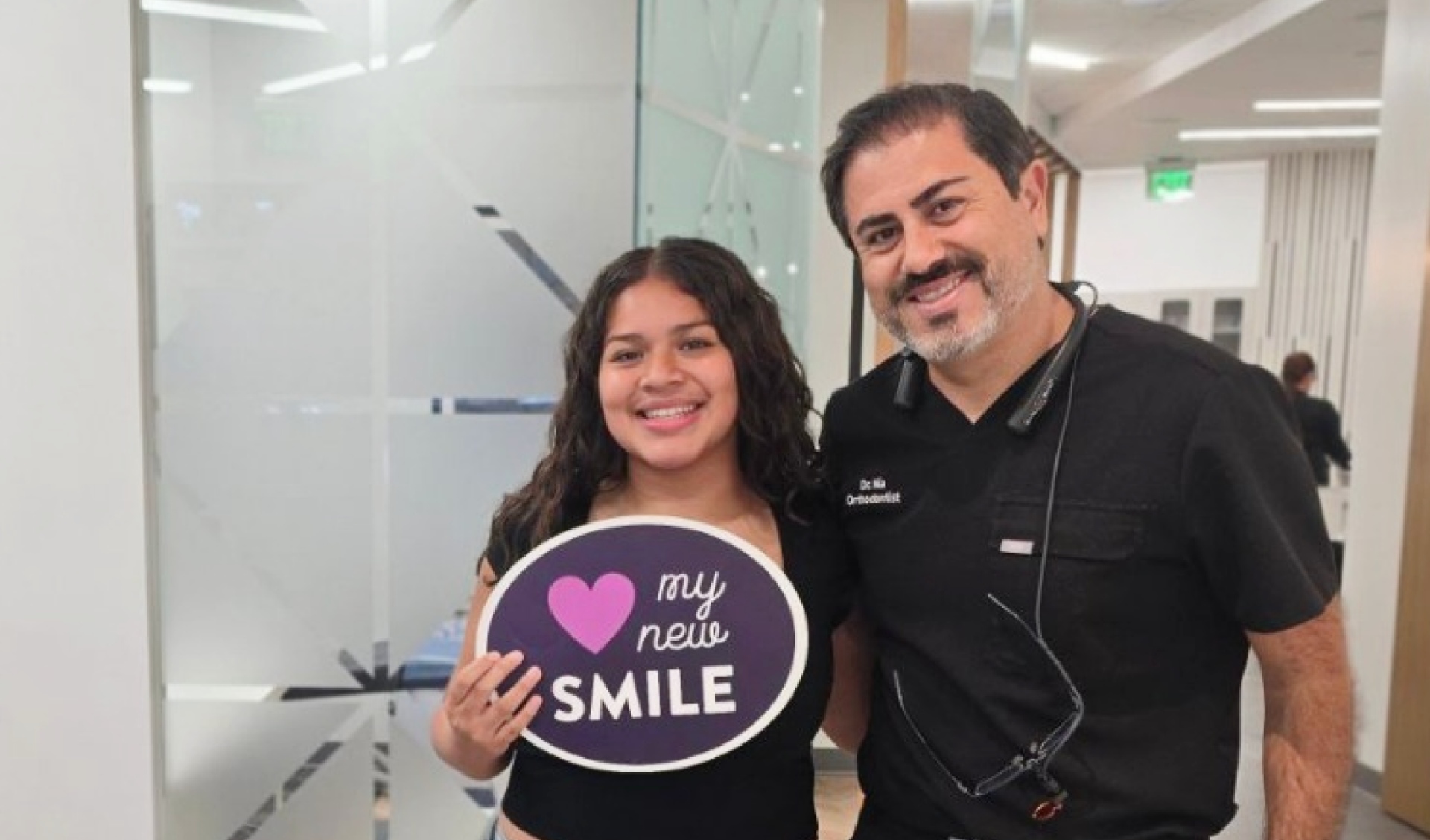 A team member and patient posing for. a picture