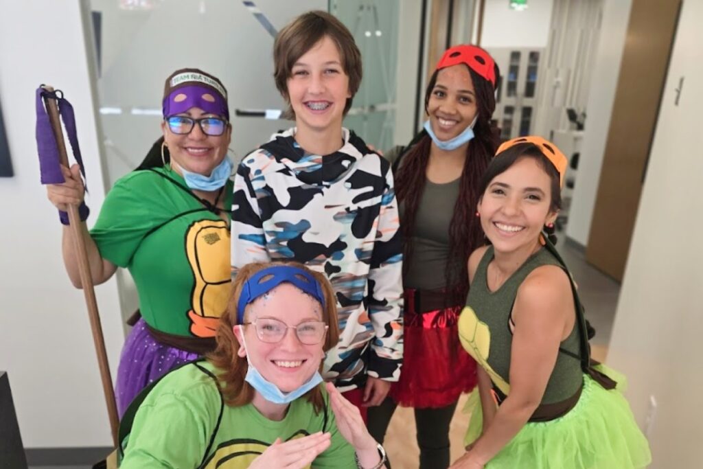 The orthodontic team in costume with a patient