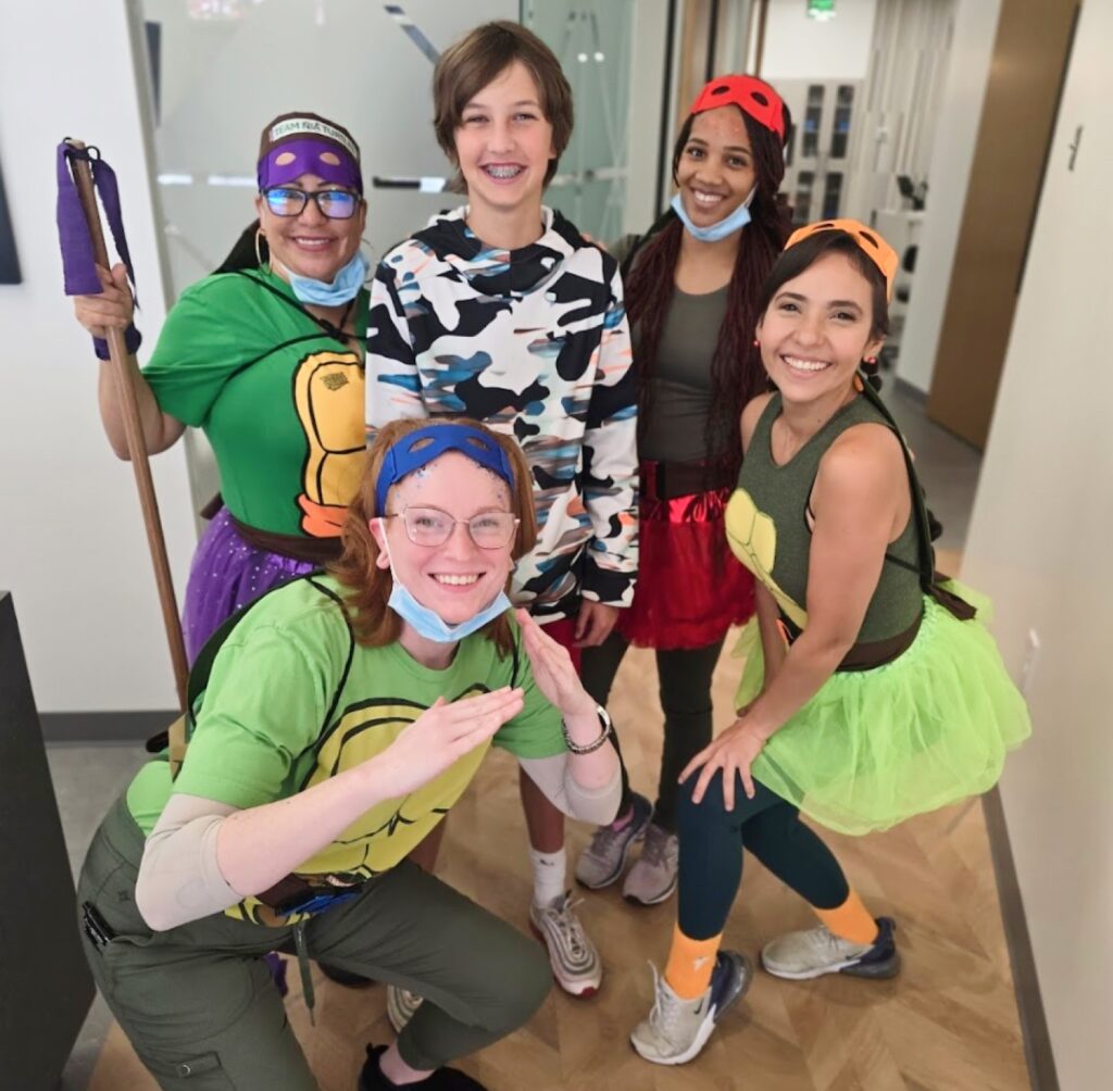 The orthodontic team in costume with a patient